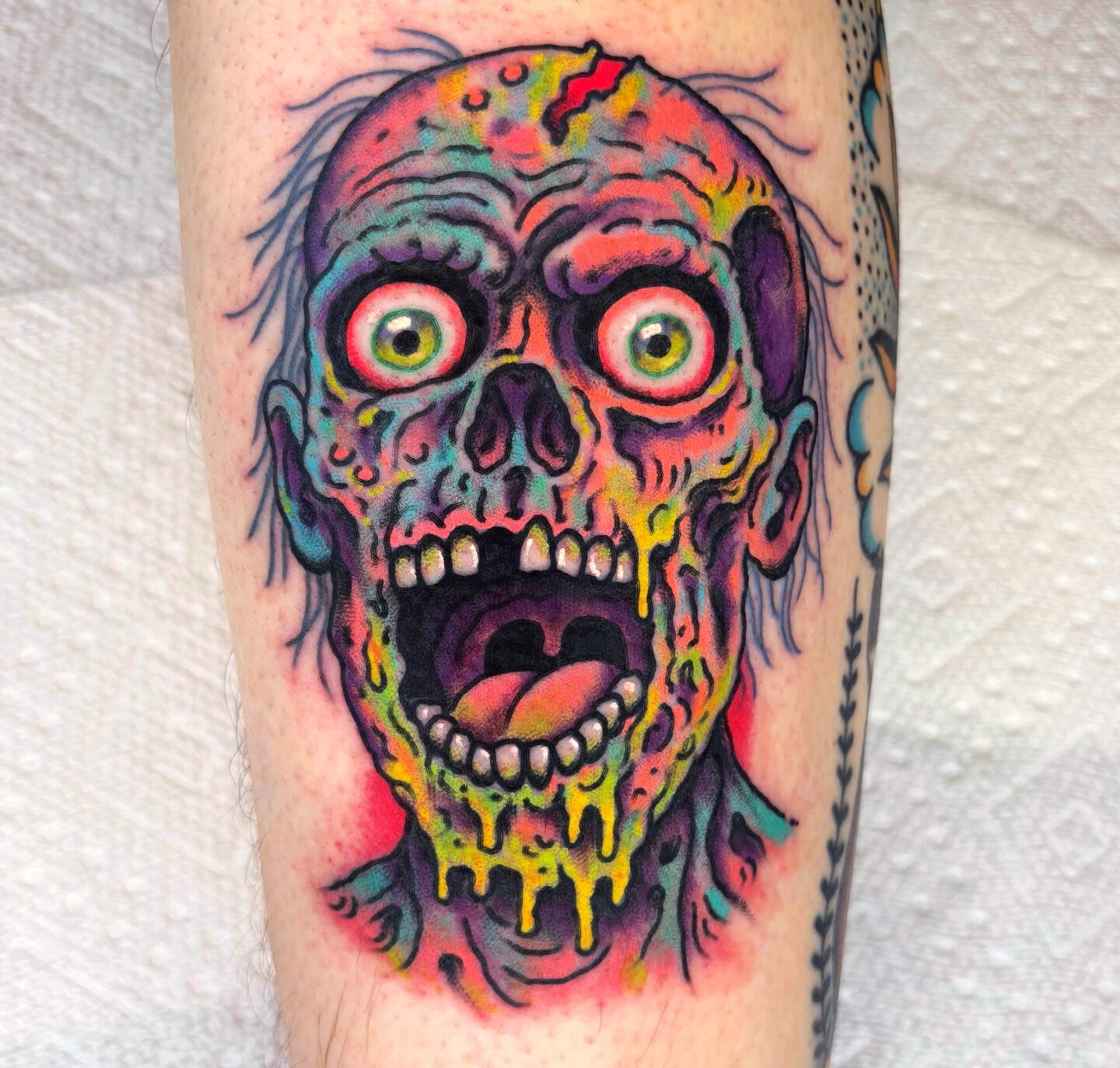 A colorful creepy tattoo of a zombie by Randy Conner in Portland, Oregon